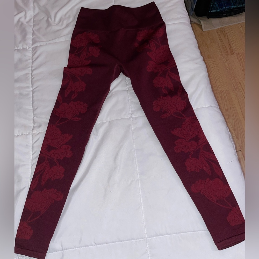 Red women’s Fabletics leggings with floral patterns